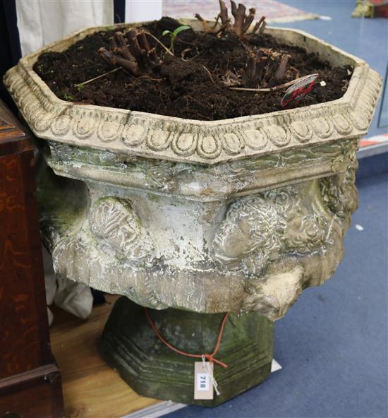 An octagonal reconstituted stone replica of the Warwick vase, (handles deficient), H.65cm